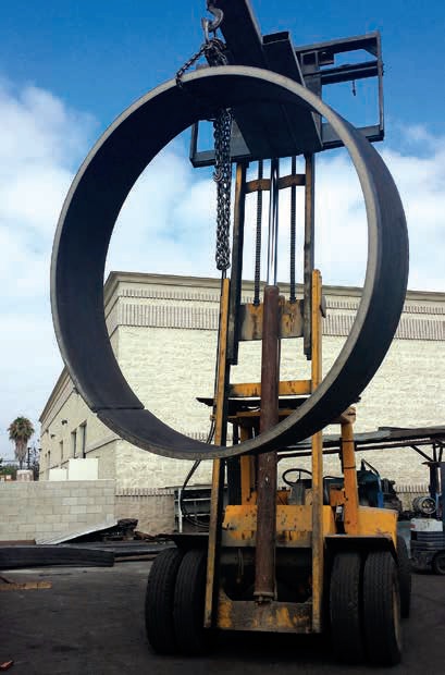 A large metal ring sitting on top of a forklift.