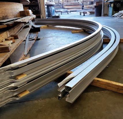 A pair of curved rails in the middle of construction.