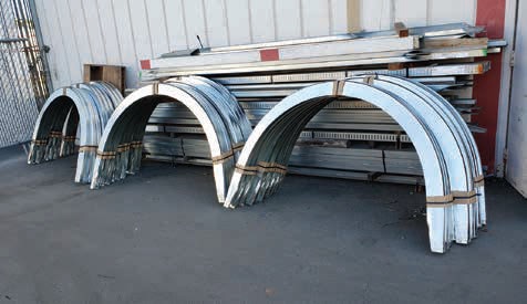 A couple of metal arches sitting on top of concrete.